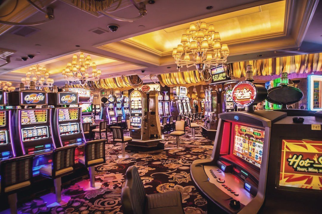 Elegant casino gaming floor with chandeliers under warm, muted light