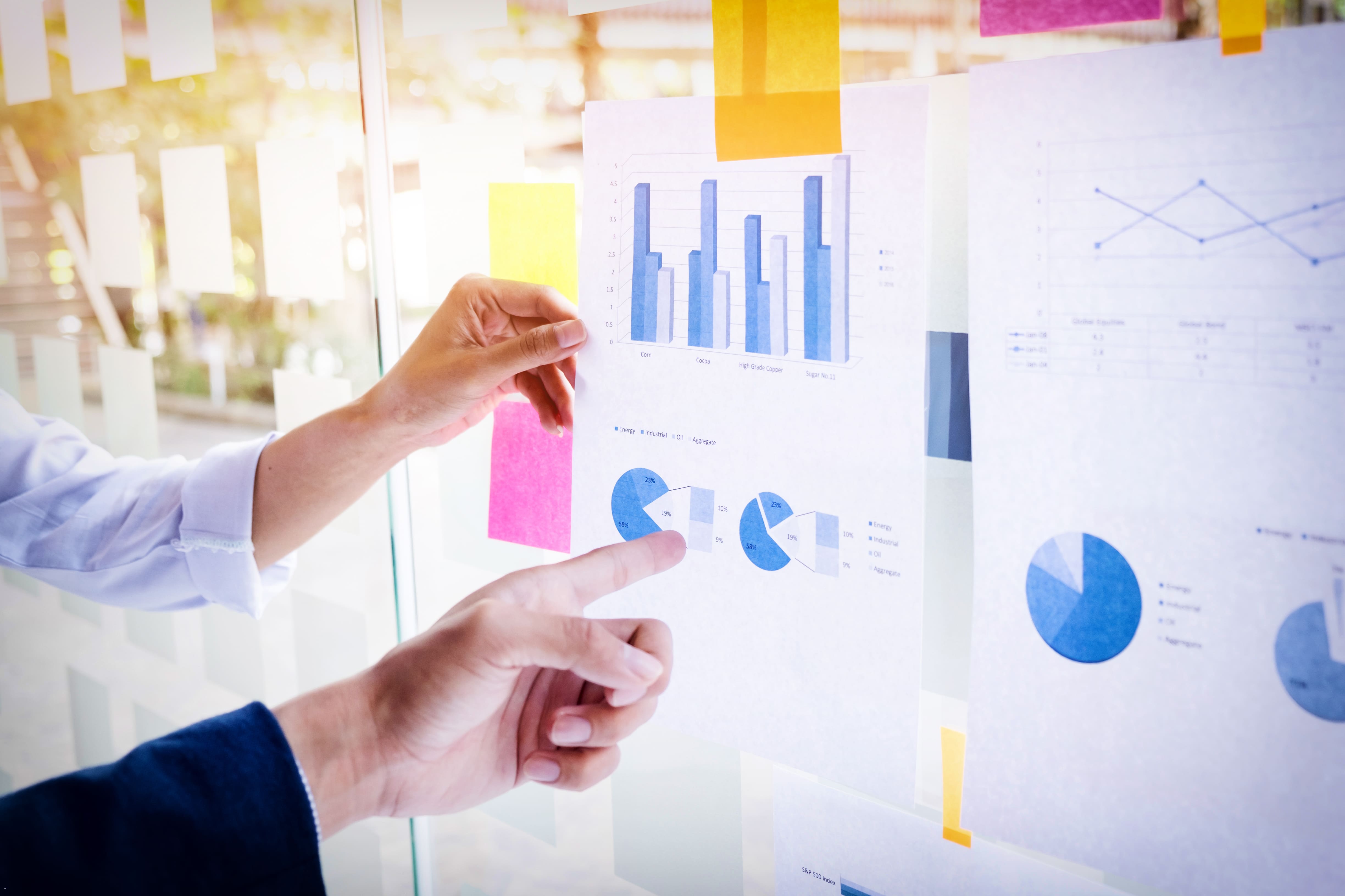 Business team reviewing strategy with data overlays