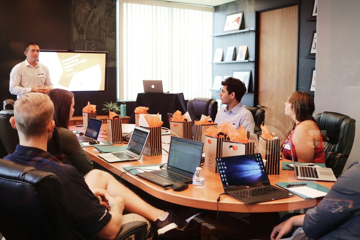Retail team in a boardroom session reviewing a presentation together