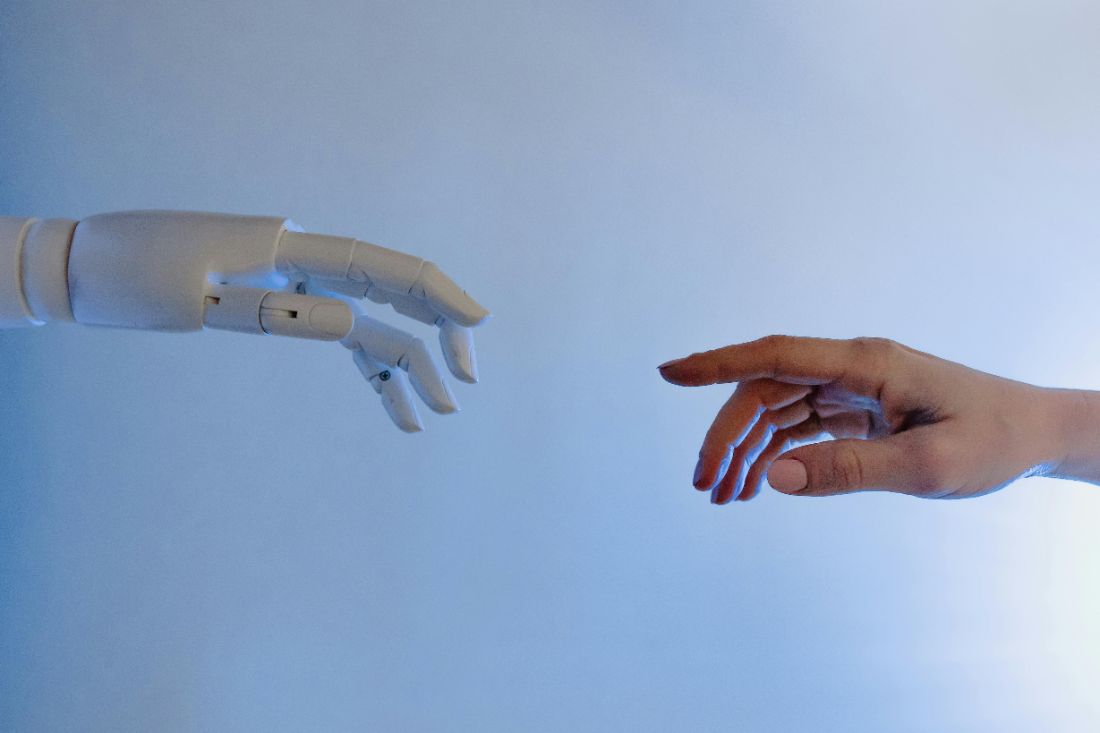 Human and AI hands reaching toward each other
