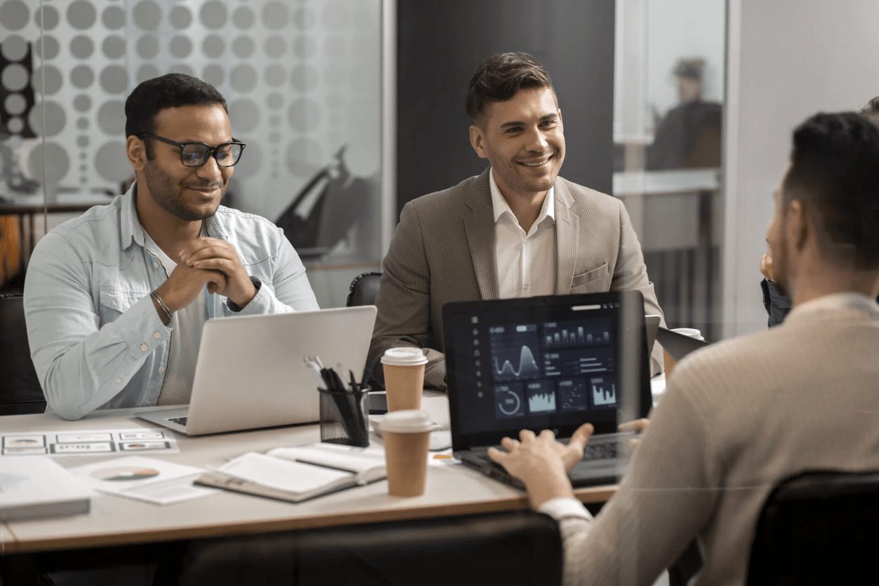 Scadea consultants collaborating with a client around a data dashboard