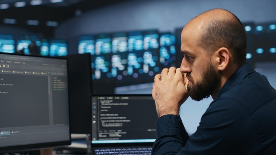 IT support monitoring energy consumption across server racks
