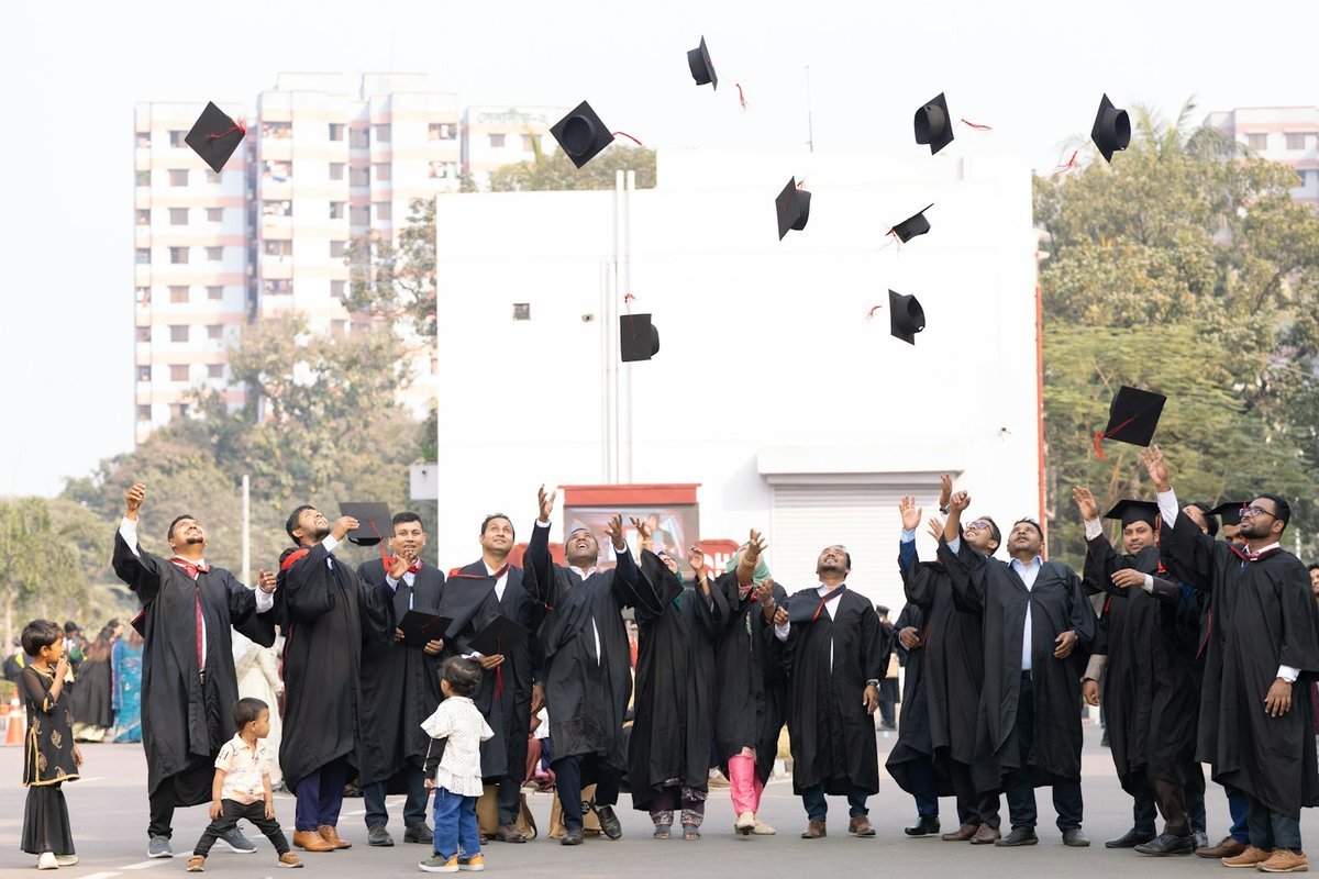 Graduates throwing their caps in the air after a commencement ceremony