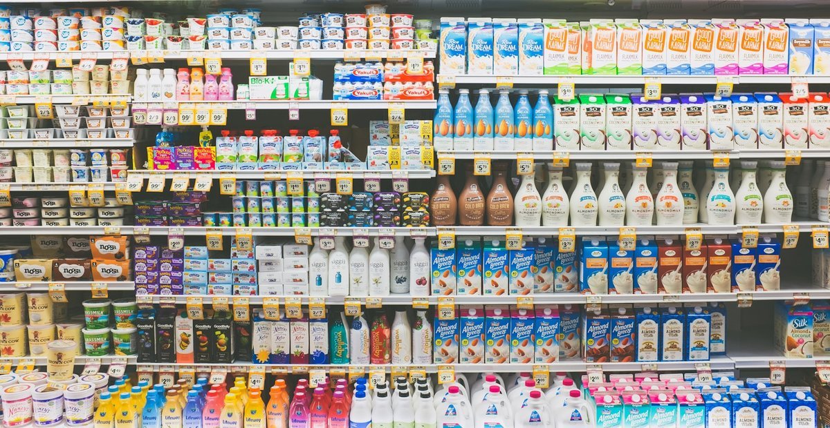 Supermarket chiller shelves stocked with priced product ranges