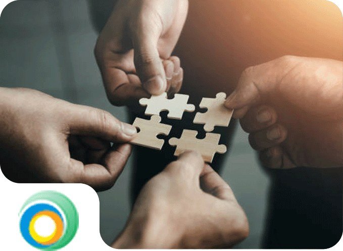 Several hands fitting puzzle pieces together
