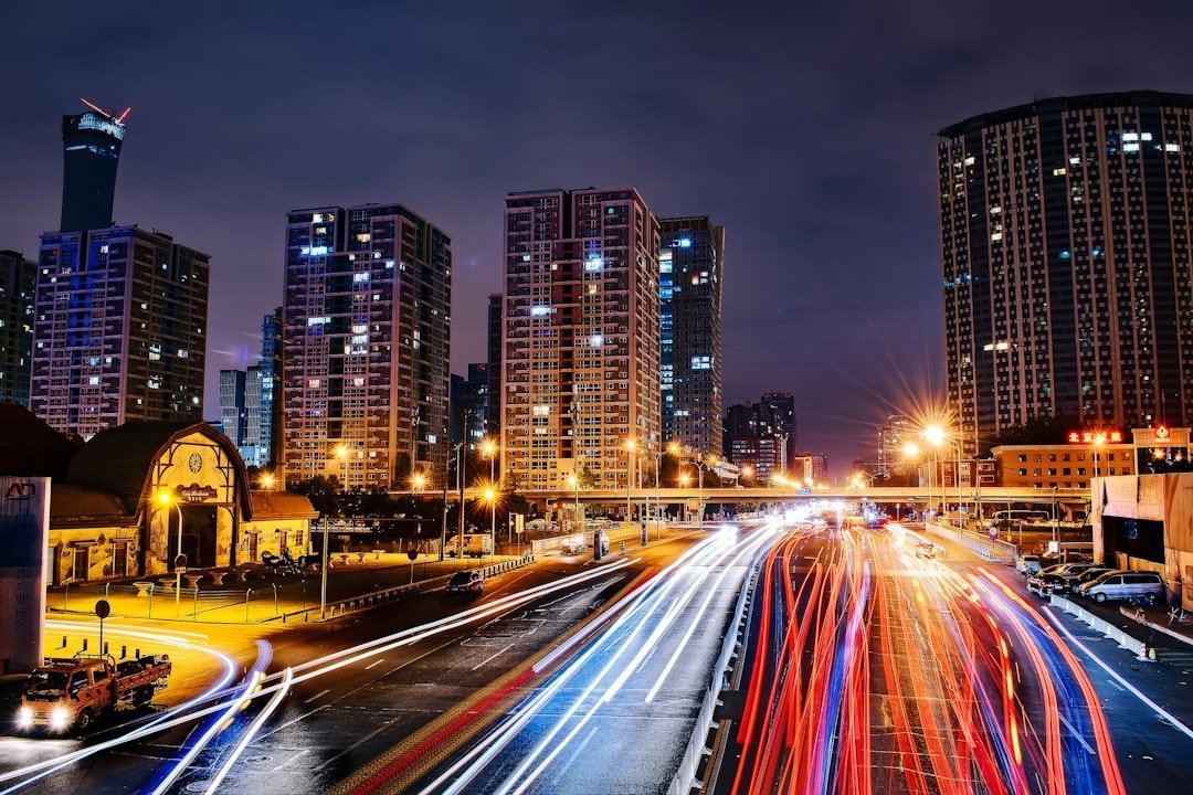 City at night with road and transit light trails