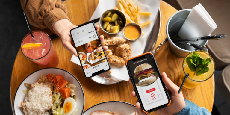 Diners holding smartphones with social media and AR menus over food.