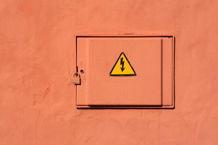Locked orange electrical panel with high voltage warning sign.