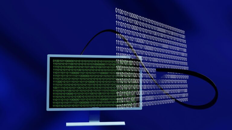 Monitor displaying binary code connected to flowing data stream.