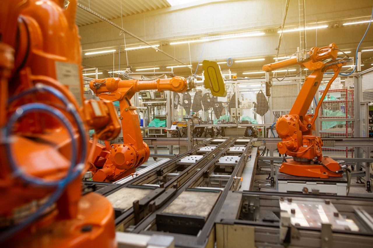 Industrial robotic arms working along an automated automotive assembly line