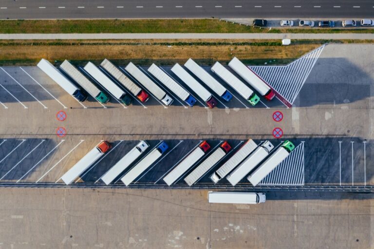 Aerial view of tractor trailers parked in angled rows at a freight terminal
