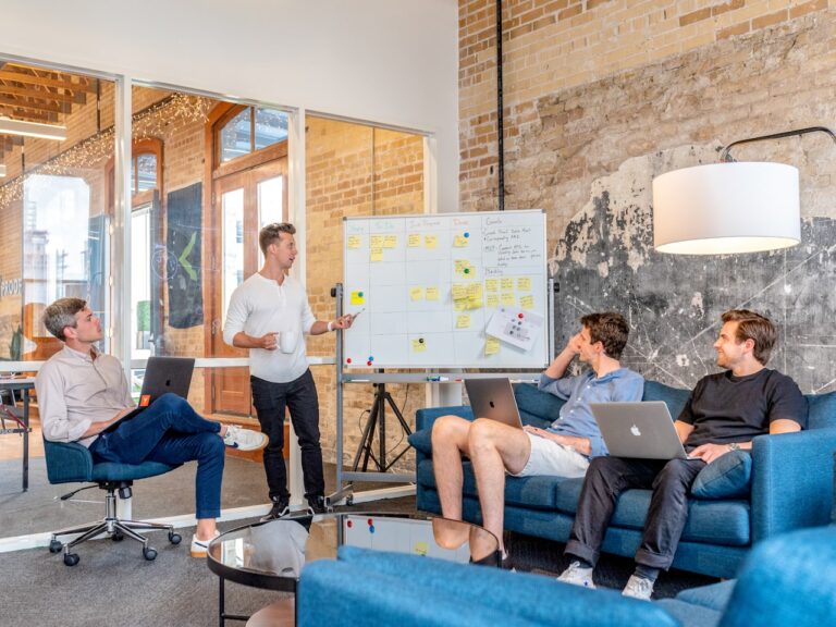 Team discussing a project board covered in sticky notes during a planning session