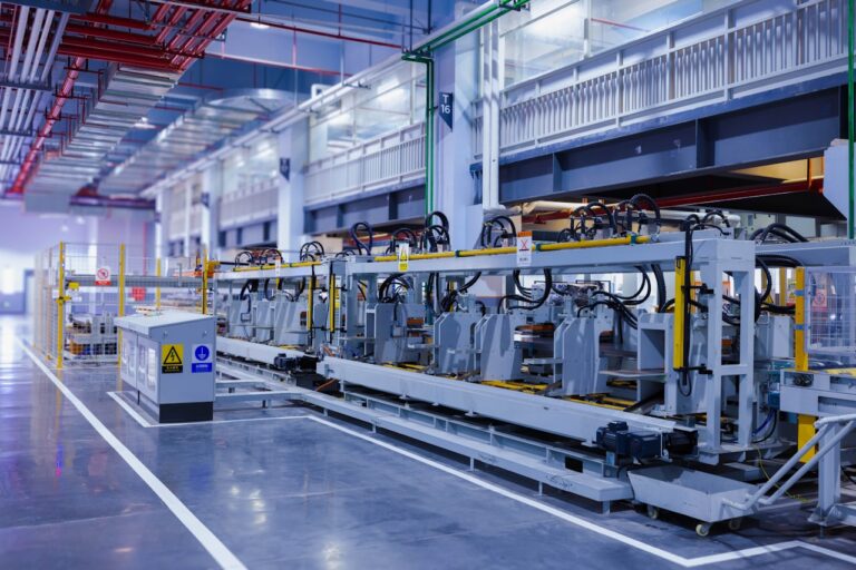 Modern automated production line with networked control cabinets on a clean factory floor