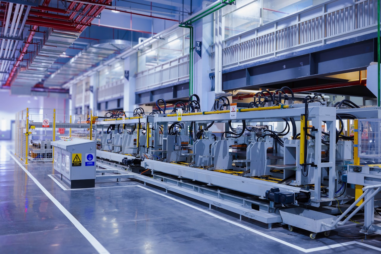 Modern automated production line with networked control cabinets on a clean factory floor