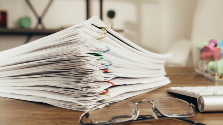 Stack of unstructured paper documents on a desk